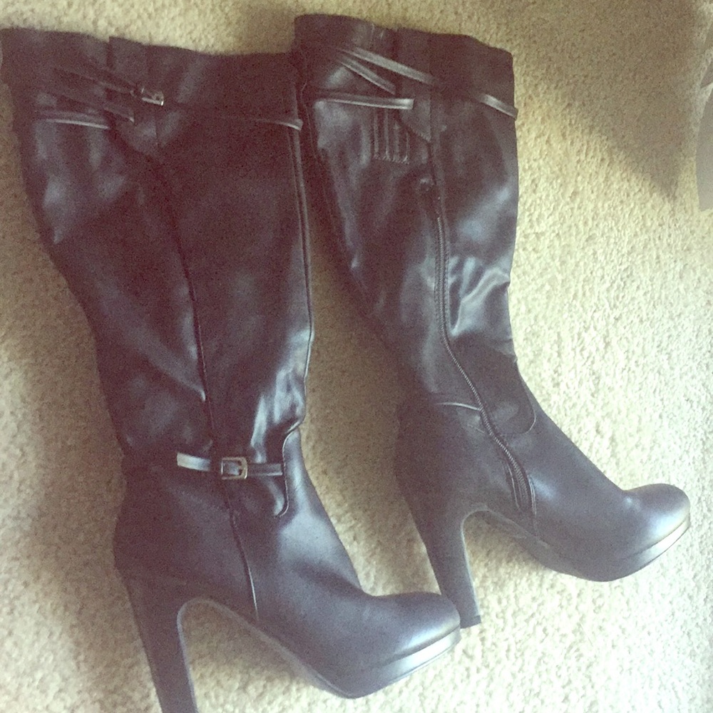 Black leather heel boots with buckle detail